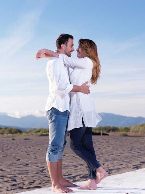 happy young romantic couple in love have fun on beautiful beach at beautiful summer day