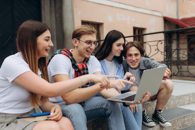 Happy young students are chatting in campus