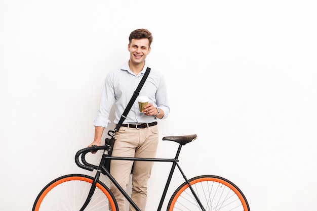 Happy young stylish man dressed in shirt carrying bag