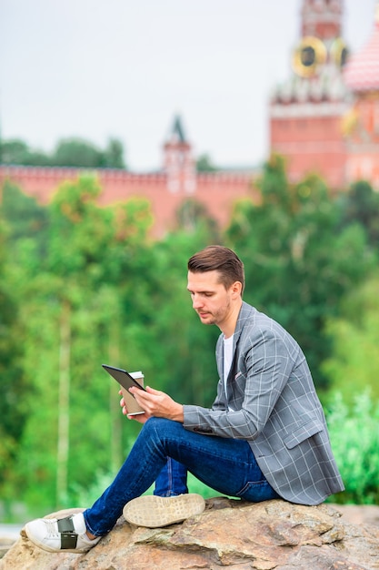 Happy young urban man in european city.