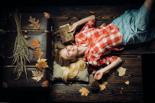 Happy young woman having fun with Leaf fall. Fashion portrait of beautiful sensual woman. Leaf fall. Having fun. Attractive young woman wearing in fashionable seasonal clothes having Autumnal mood.