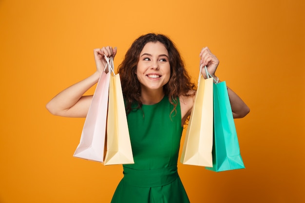 Happy young woman holding shopping bags.