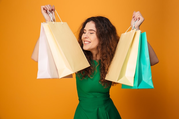 Happy young woman holding shopping bags.