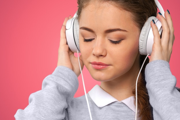 Happy young woman listening to music