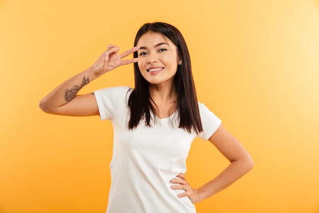 Happy young woman make peace gesture.