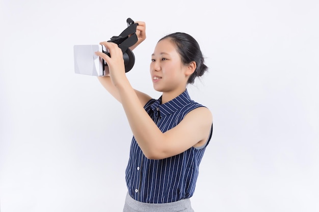 Happy young woman playing on VR glasses indoor Virtual reality concept with young girl having fun with headset goggles touching air during VR experience Digital generation trend