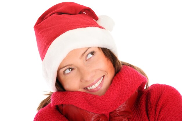 a happy young woman in Santa's hat smiling over white