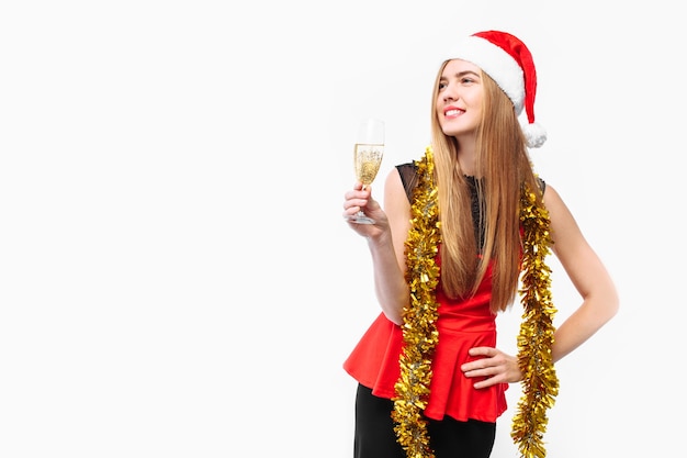 Happy young woman wearing a dress and Santa hat