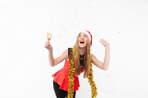 Happy young woman wearing a dress and Santa hat