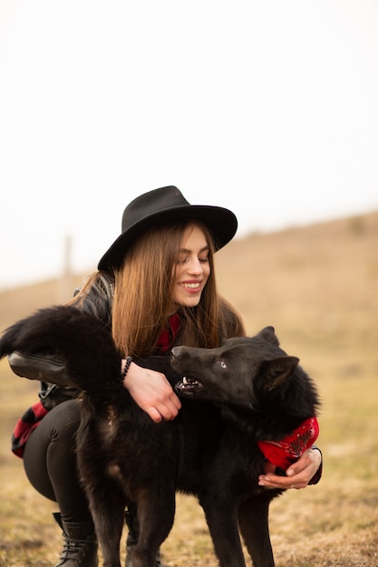 Happy young woman with black hat