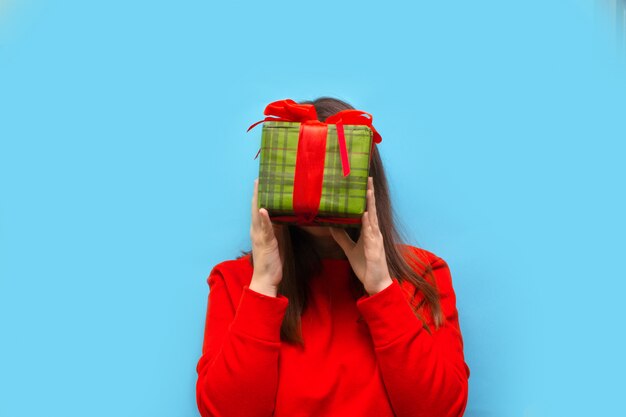 Happy young woman with Christmas gift box