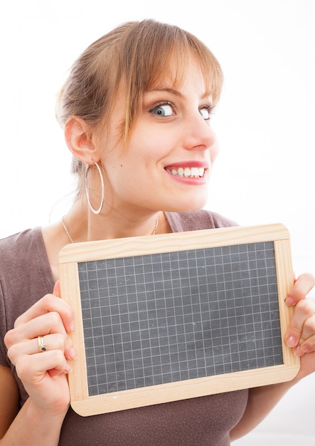 Happy young woman with small blackboard, isolated