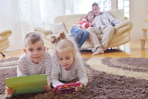 hapy young family have fun  with their children at modern living room home indoors