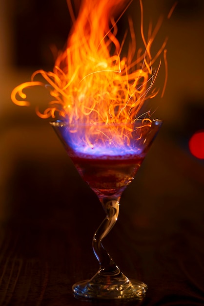 Hard drink with fire and sparks on bar