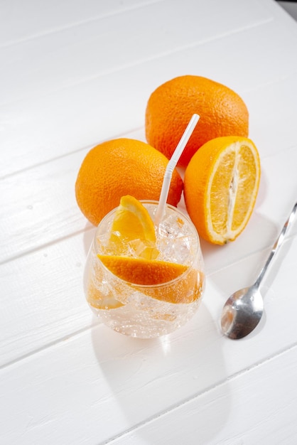 Hard seltzer cocktails alcoholic beverage with tonic and orange on a light background top view