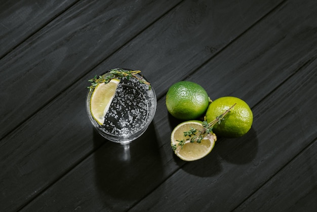 Hard seltzer with lime on a dark wooden background top view