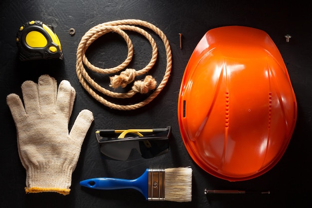 Hardhat and tools  on black background