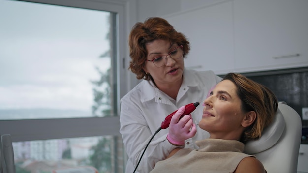 Hardware professional facial treatment making by dermatologist in clinic closeup