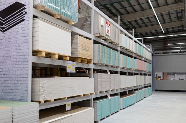  hardware store with counters of gypsum fiber sheet from different manufacturers.