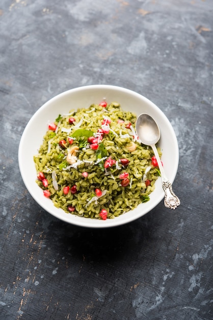 Hariyali Poha, Green Masala Pohe or flattened rice served in a bowl, selective focus