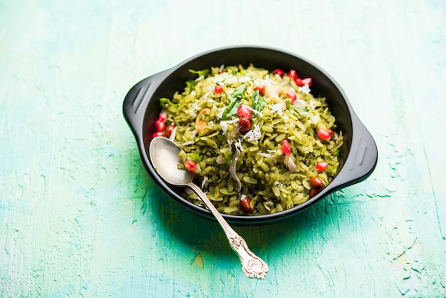 Hariyali Poha, Green Masala Pohe or flattened rice served in a bowl, selective focus