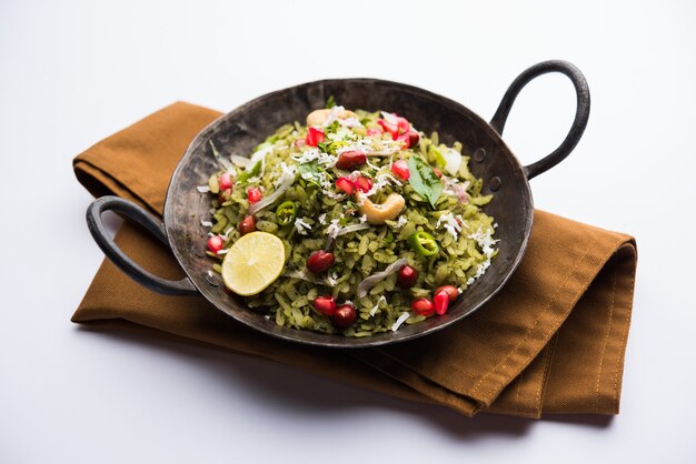 Hariyali Poha, Green Masala Pohe or flattened rice served in a bowl, selective focus