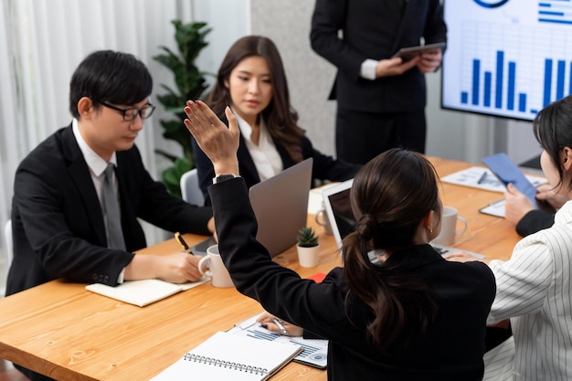 Harmony group businesspeople raising hand in meeting room during presentation