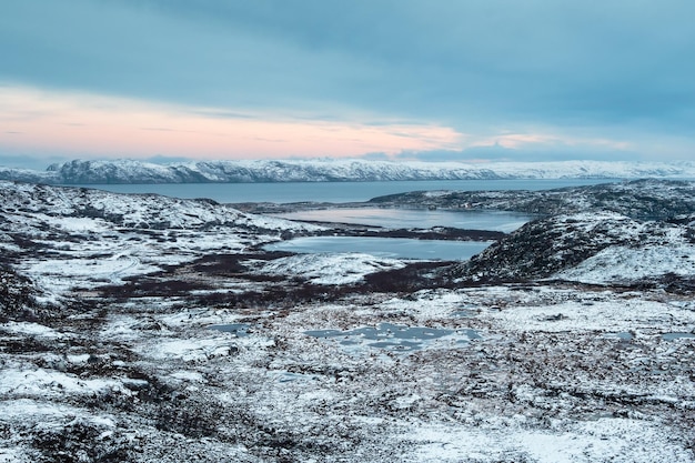 Harsh Arctic landscape Frozen tundra with icy lakes at dawn Amazing northern nature