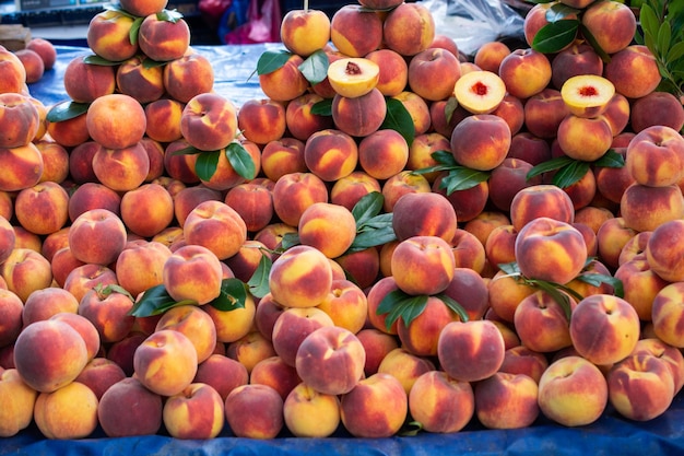 Harvest of fresh tasty peaches fruit at farmers Agricultural products sale in market