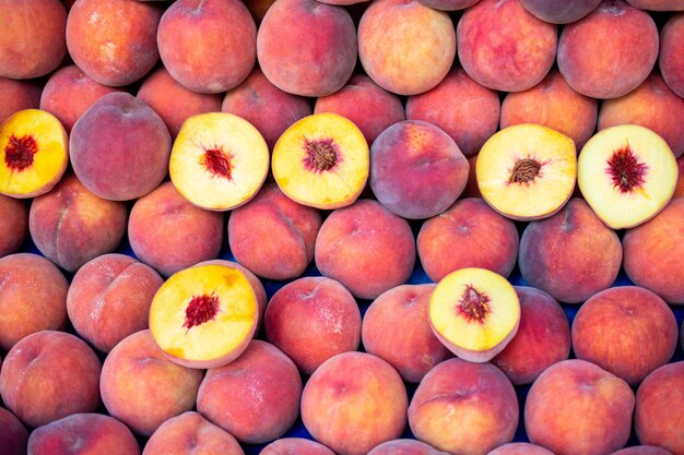 Harvest of fresh tasty peaches fruit at farmers Agricultural products sale in market