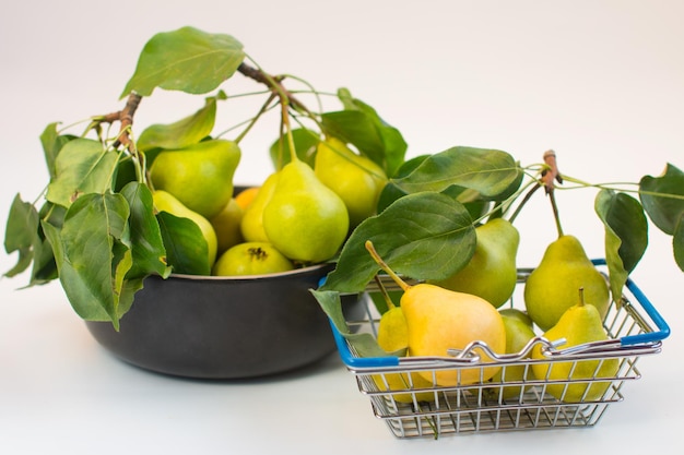 Harvest of ripe pears in a basket Autumn harvest on a white background