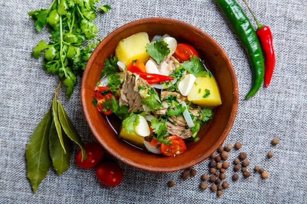 Hashlama in a clay plate. Ingredients Beef ribs, potatoes, herbs, garlic.