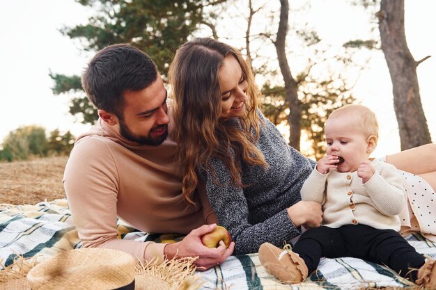 Haves picnic Happy family of mother family and little baby rests outdoors Beautiful sunny autumn nature