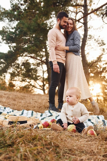 Haves picnic Happy family of mother family and little baby rests outdoors Beautiful sunny autumn nature