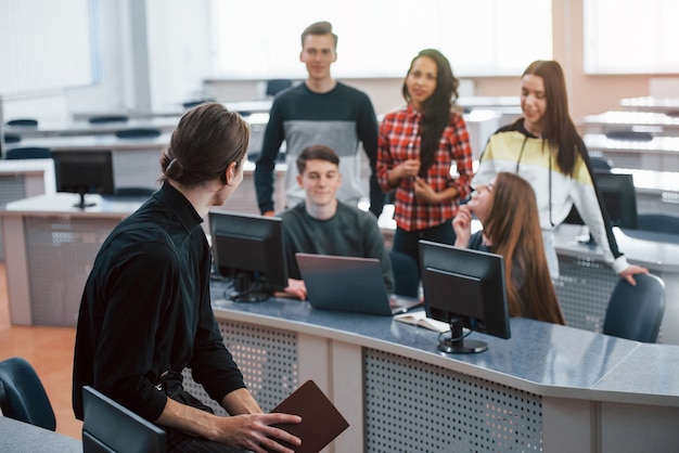 Having a speech. Group of young people in casual clothes working in the modern office.