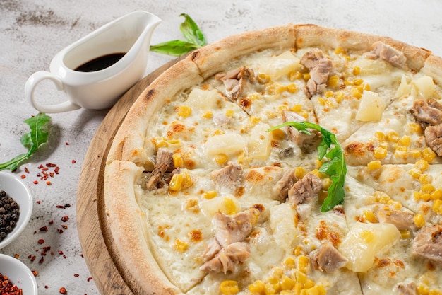 Hawaiian pizza with chicken meat pineapple and corn