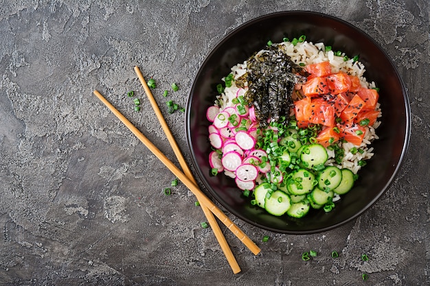 Hawaiian salmon fish poke bowl with rice. Top view. Flat lay