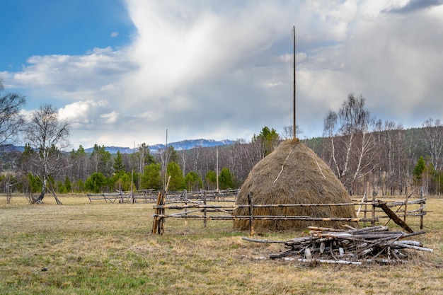 Haystack and wooden fence in the mountains