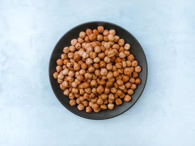 Hazelnut on light blue table, Top view