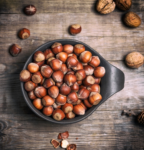 Hazelnut in a shell in a brown clay cup