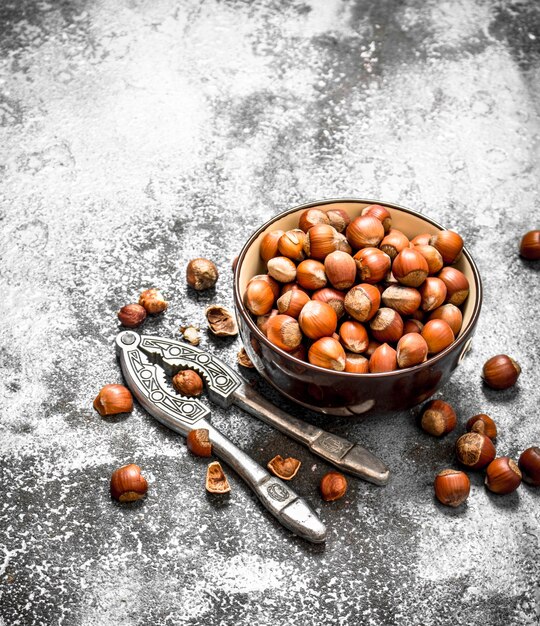 Hazelnuts in a bowl with a Nutcracker.