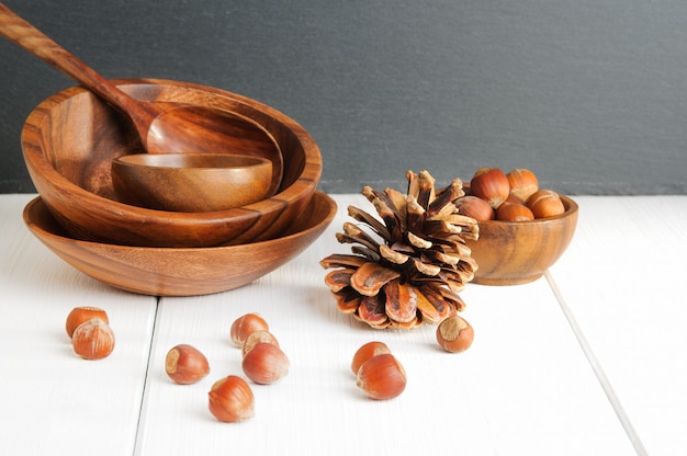 Hazelnuts, pinecone and wooden utensils