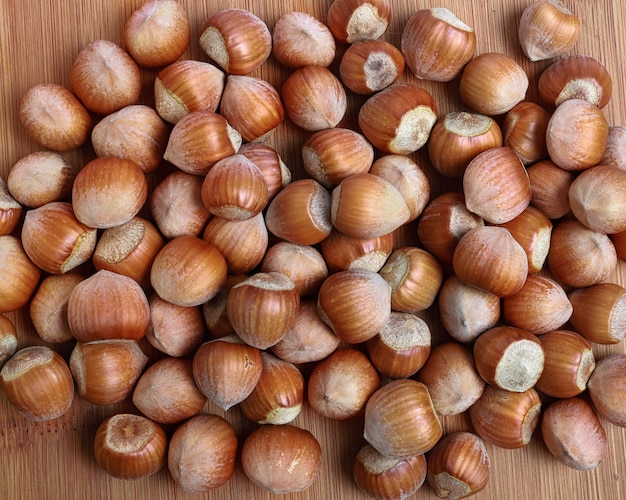 Hazelnuts in shells on a wooden background