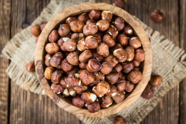 Hazelnuts on vintage wooden background selective focus