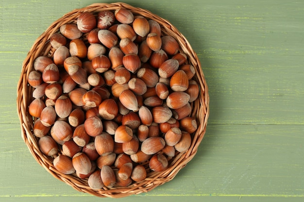 Hazelnuts on wicker mat on wooden background