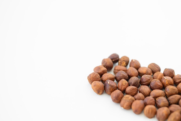 Hazelnuts without shell on a white background isolated Pile of hazelnut closeup