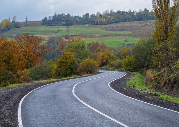 Hazy and overcast Carpathian Mountains and highway on mountain pass Ukraine