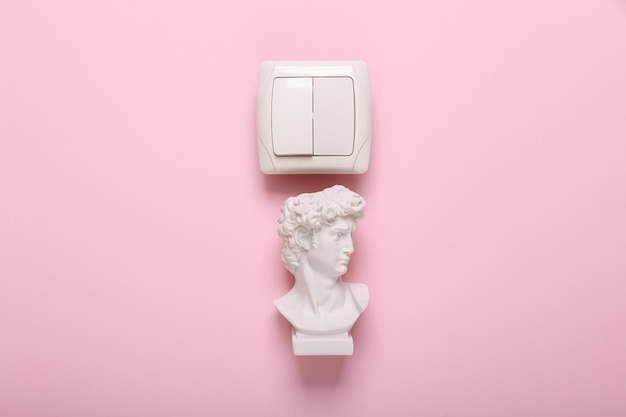 Head of david with light switch on pink background Concept pop Contemporary still life fresh idea layout