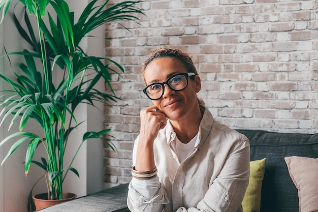 Head shot portrait smart confident smiling middle age caucasian woman standing with folded arms at home Attractive young lady entrepreneur girl freelancer looking at camera posing for photoxA