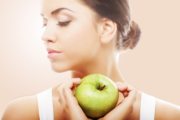 Head shot of woman holding apple